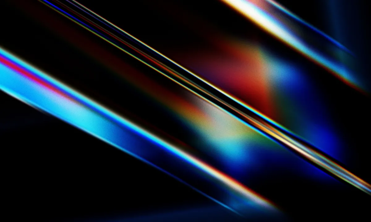 Abstraction de lumières multicolores fluos sur fond noir.