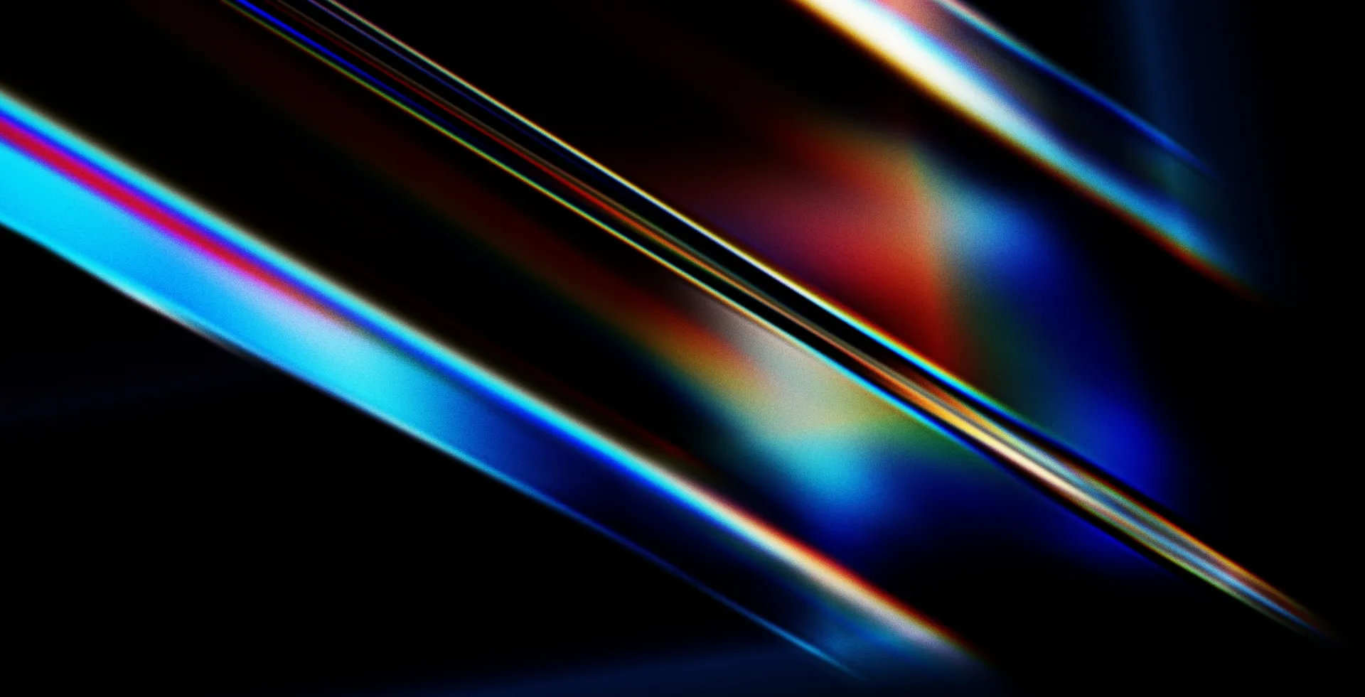 Abstraction de lumières multicolores fluos sur fond noir.